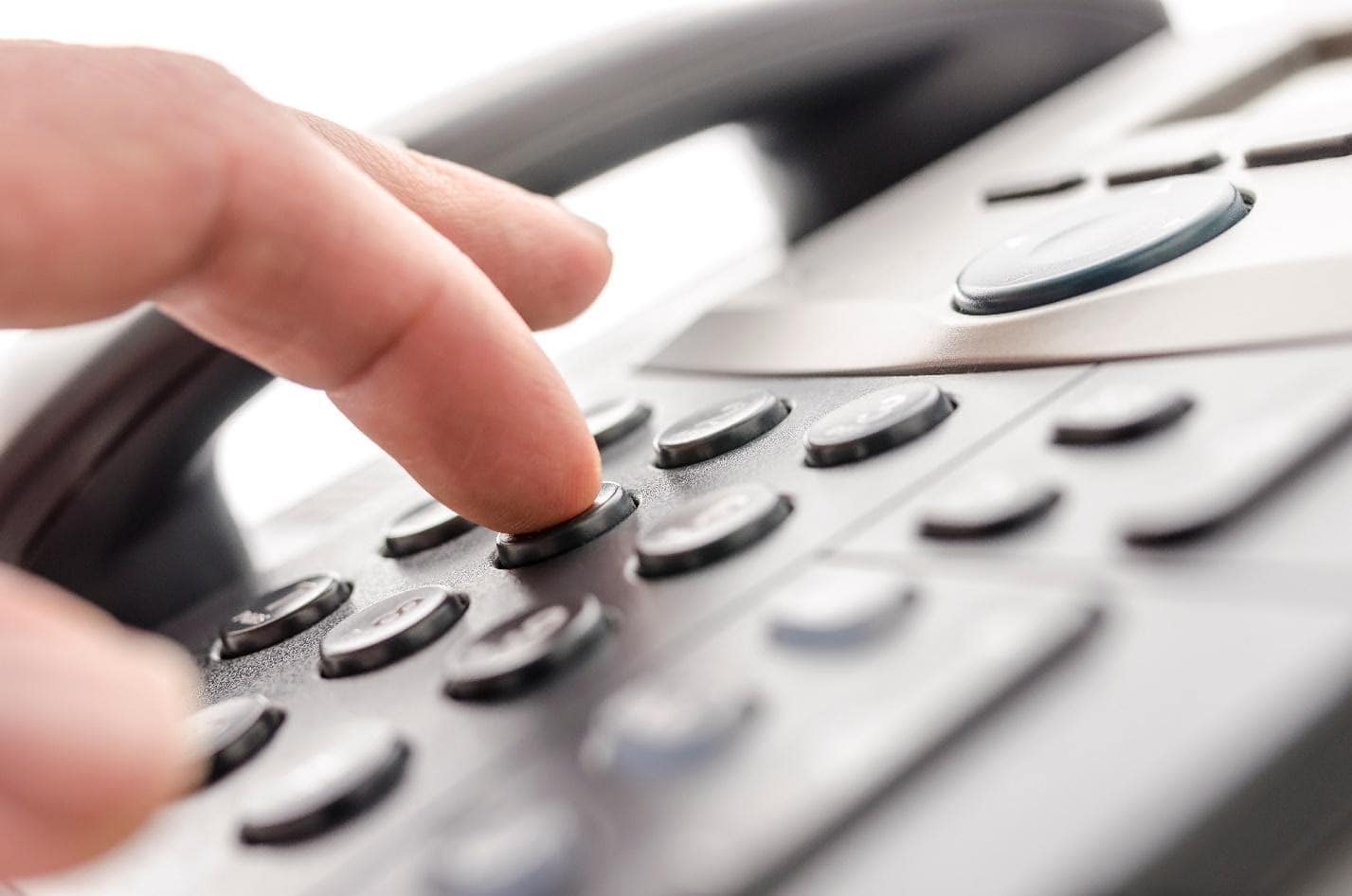 fingers on VOIP phone